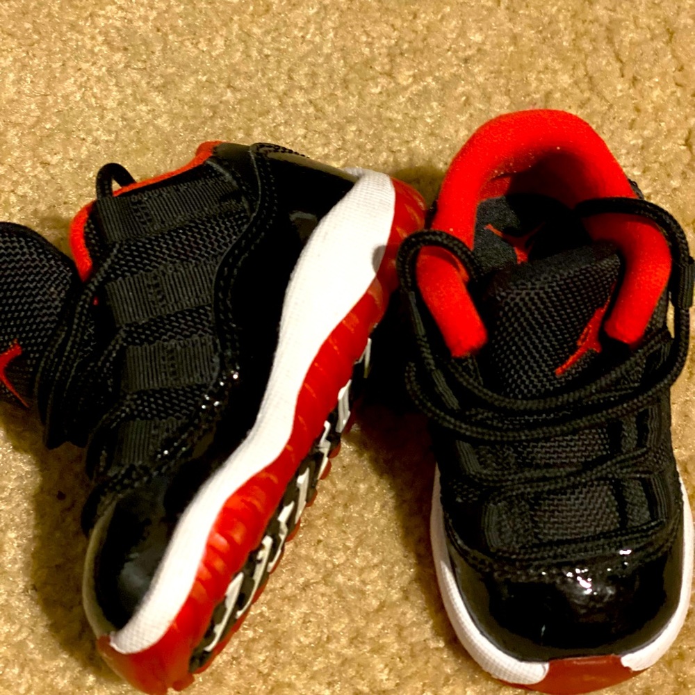 Infant 4C Retro Jordan’s, color black/white patent leather with red bottoms.